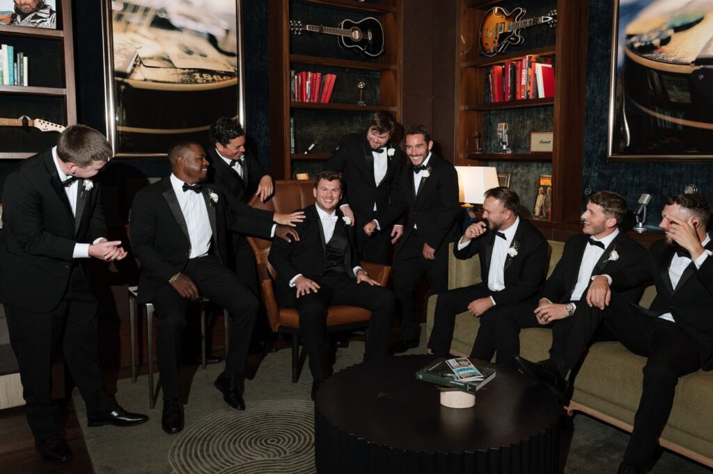 candid groomsmen photo at the country music hall of fame wedding venue in nashville