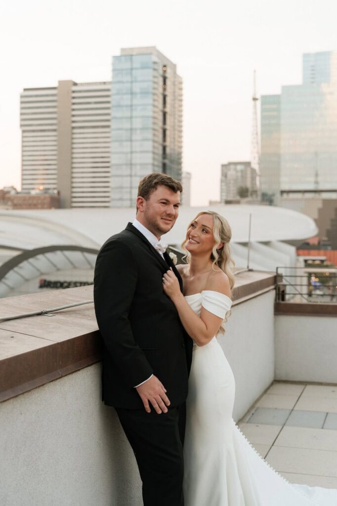 bride admiring her groom in front of the nashville skyline