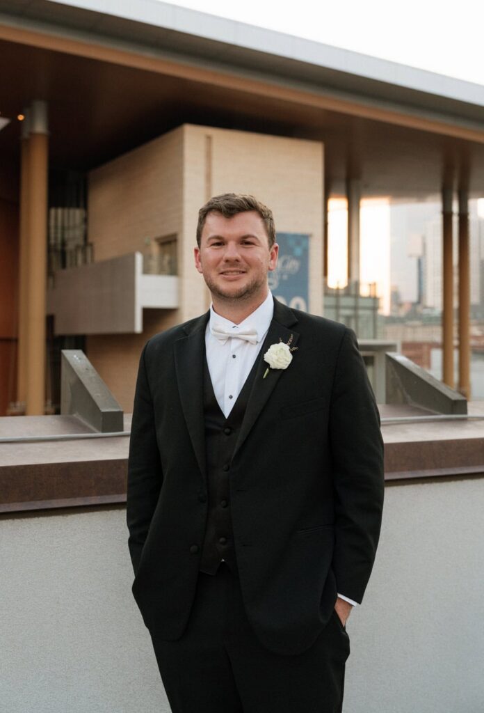groom posing on the rooftop at nashville wedding venue