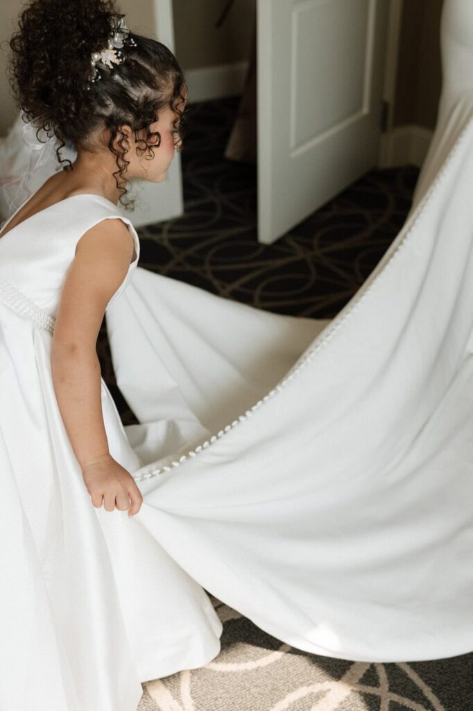 flower girl helping the bride getting ready at downtown nashville wedding venue