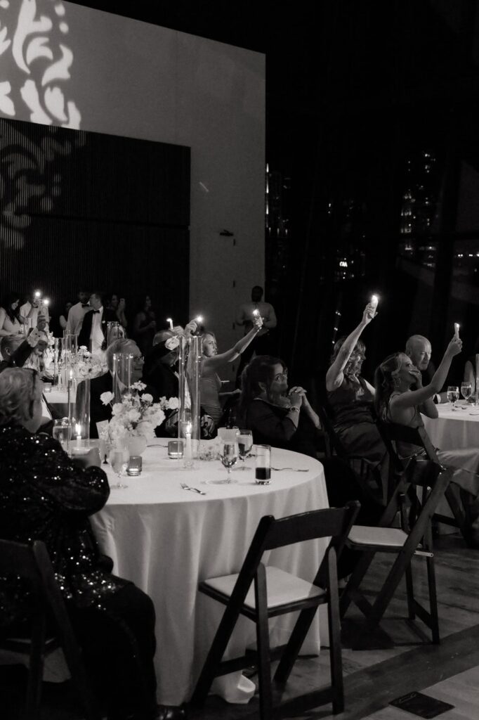 wedding guests holding up lights during the first dance